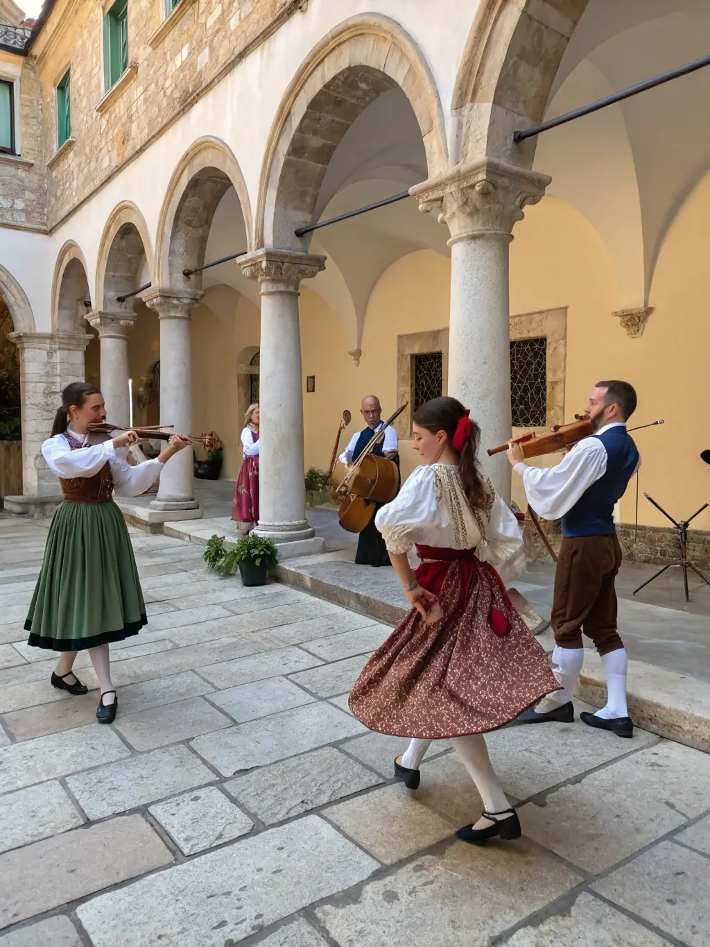 A photograph of a cultural event taking place in the Château de Davignac's courtyard, featuring traditional music and dance performances.